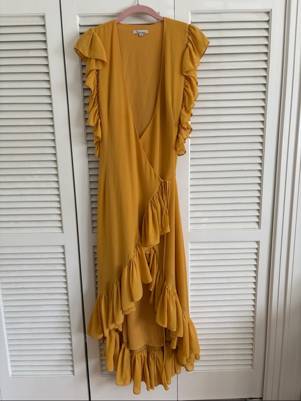 the clothing company Mustard Ruffle Wrap High-Low Dress